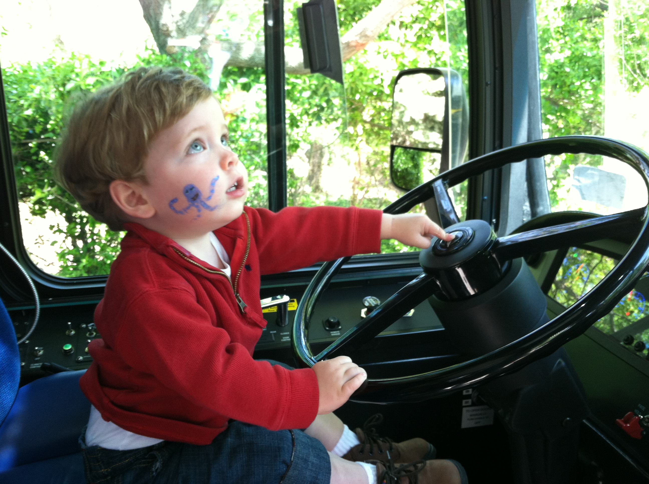 Little boy riding a Metro bus at the truck touch, a DC area family event