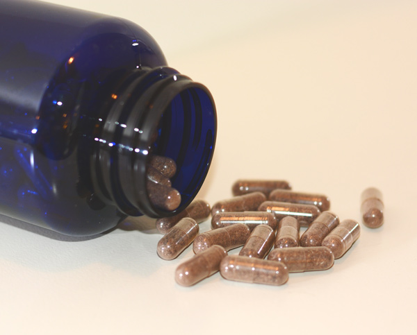 blue bottle of placenta pills filled with the benefits of placenta encapsulation
