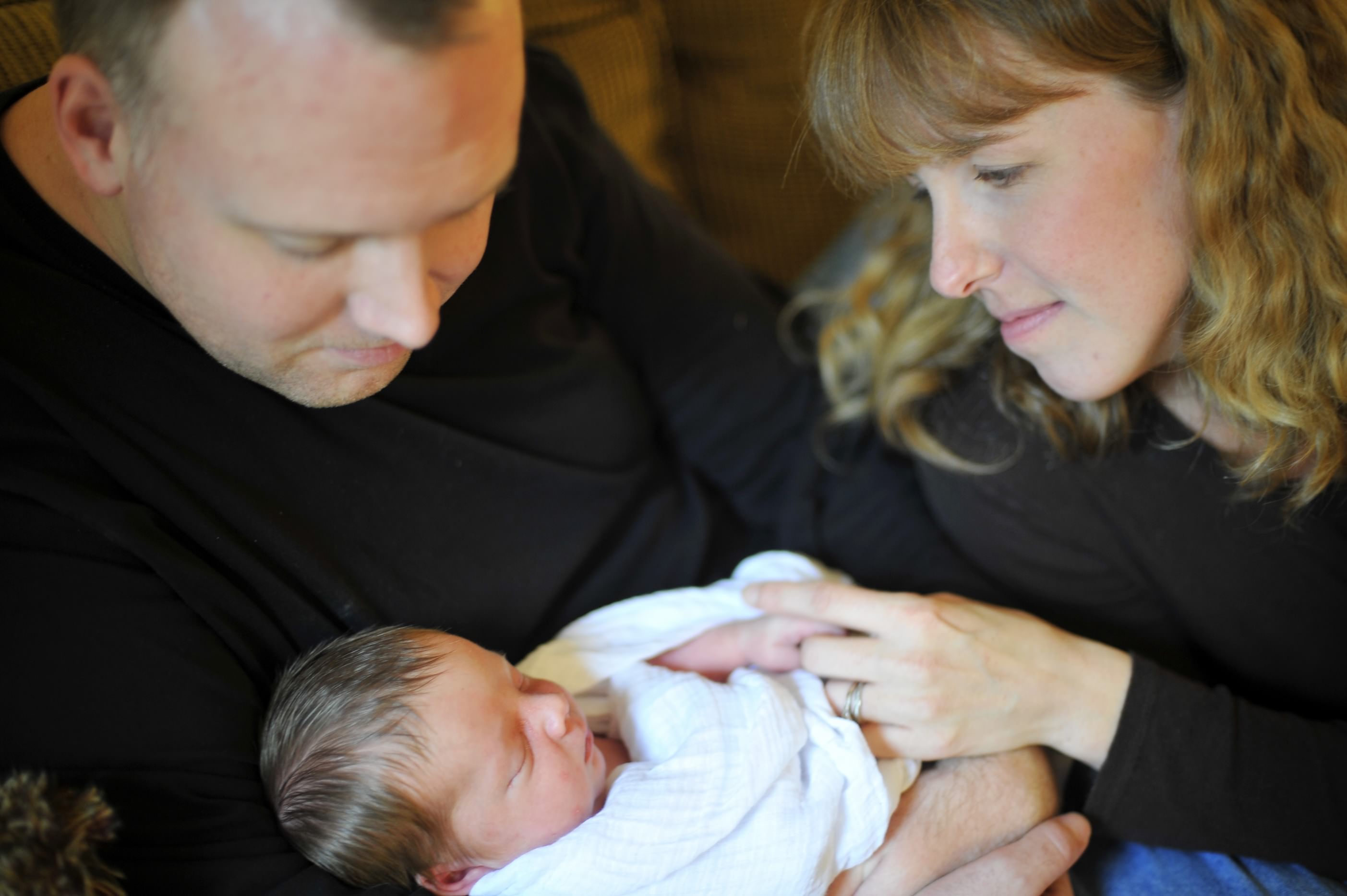 Jenny Corbett, certified provider of placenta encapsulation in Silver Spring, with her husband and newborn son.